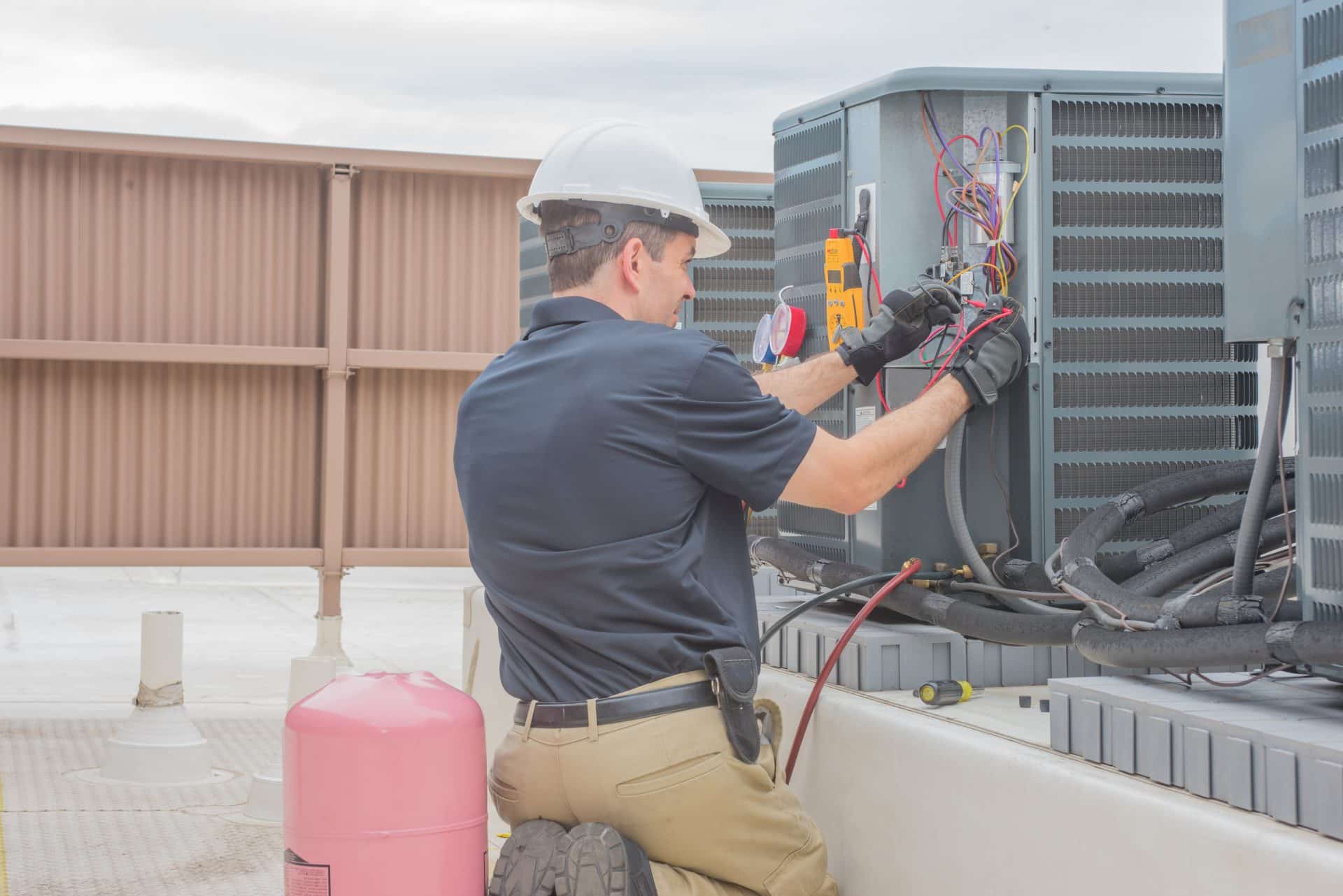 Air conditioner service technician repairing AA1 fault code