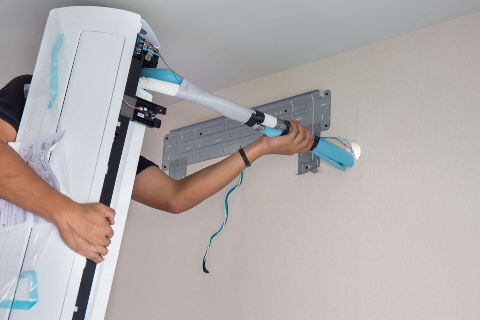 Man providing a professional split system installation in Brisbane