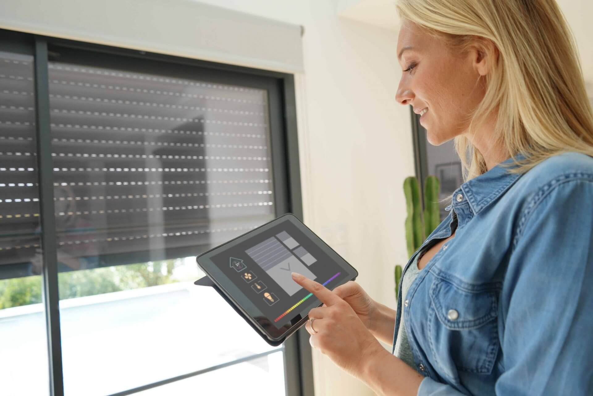 Woman controlling her blinds from a tablet