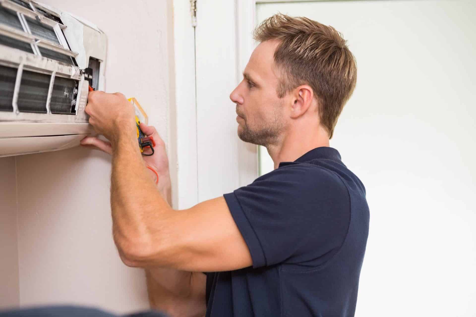 split-system-cleaning-brisbane Technician servicing & cleaning split system air conditioner in Brisbane