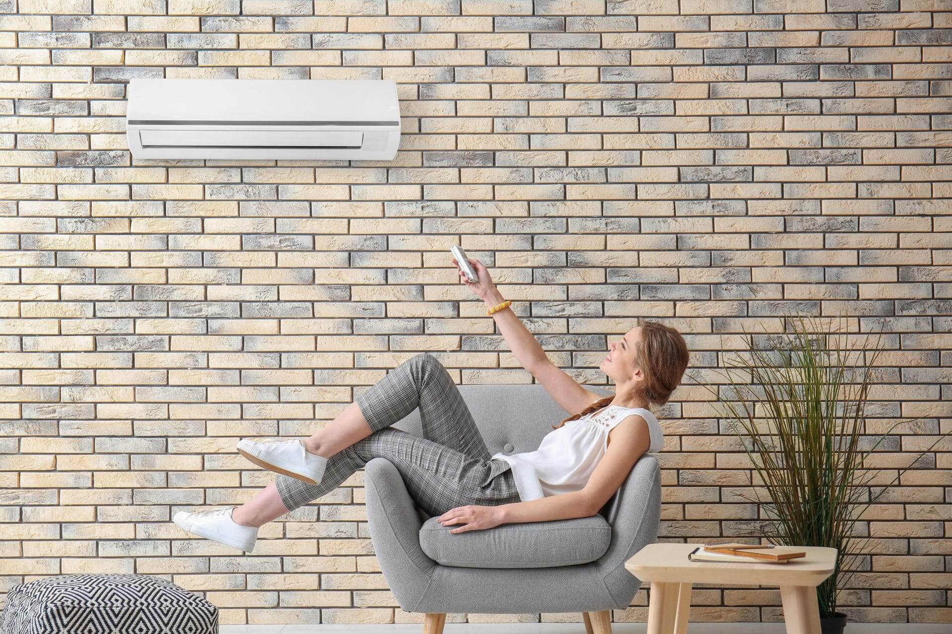 Young woman enjoying split air conditioner installation in Gold Coast