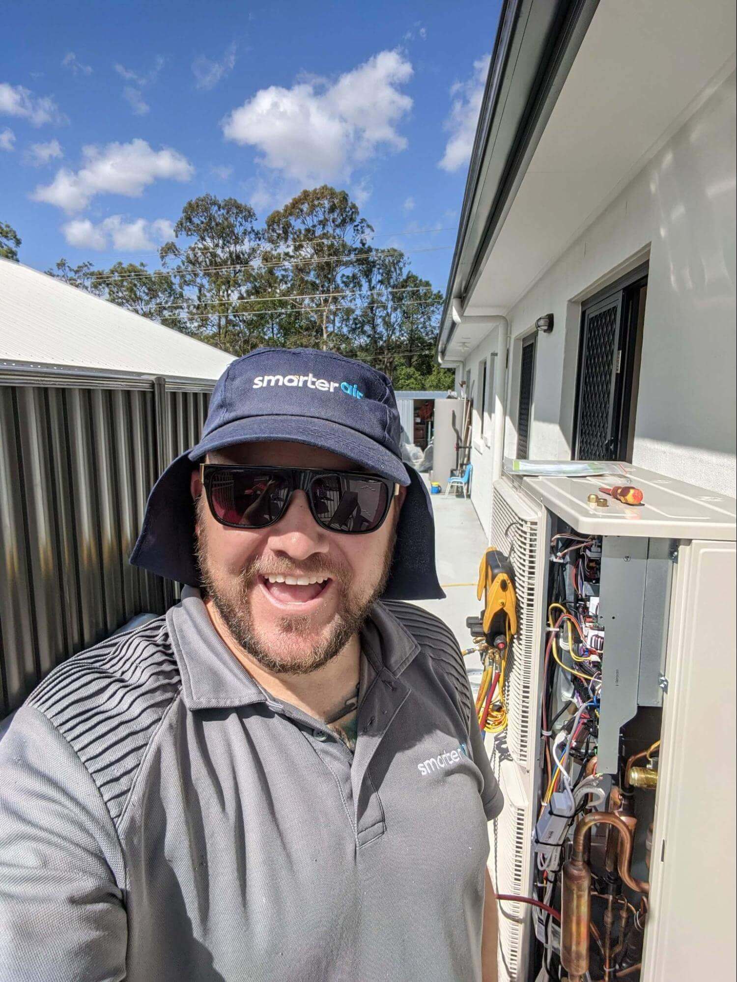 man repairing air conditioning outside